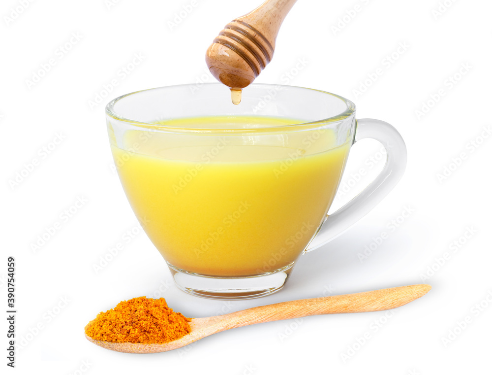 Golden milk ( turmeric latte ) in glass cup isolated on white background. Golden milk ( turmeric latte ) in glass cup isolated on white background.