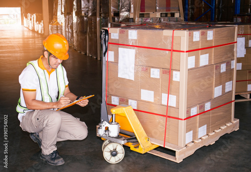 Warehouse worker holding clipboard his doing inventory management cargo shipment pallet. Checking stock, Packaging, Cargo shipment boxes, Warehousing storage.