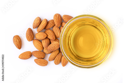 Almond oil and almonds nuts isolated on white background. Top view. Flat lay. photo