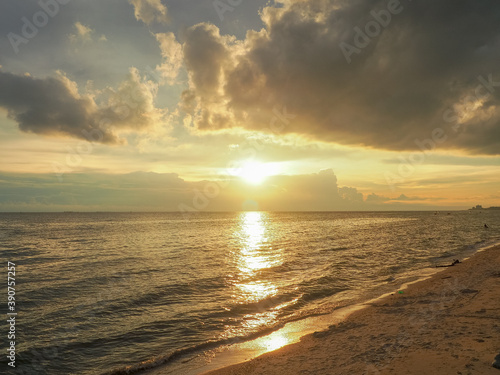 Evening atmosphere at Wonnapa Beach The golden light of the sun glitters on the sea. © aeysiriamnat
