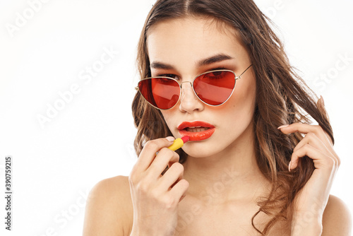 Fashionable brunette in sunglasses with makeup lipstick model