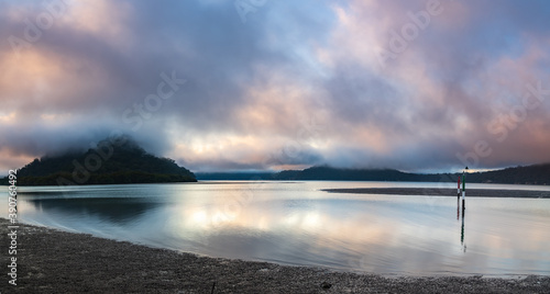 Misty morning panorama with clouds at the river