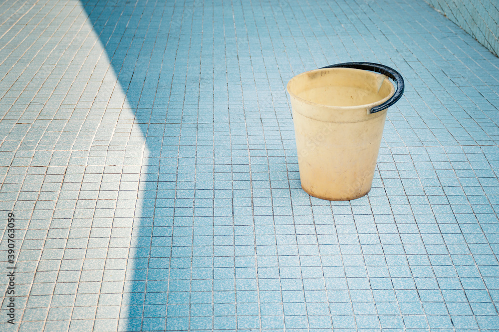 A bucket in an empty pool