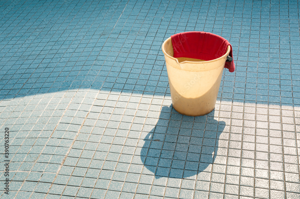 A bucket in an empty pool