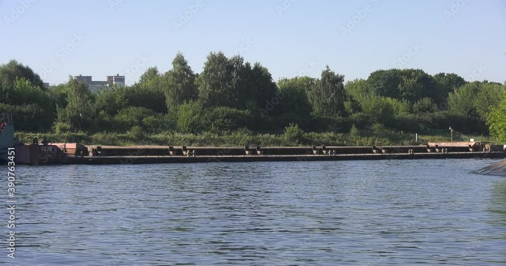 4K high quality calm windless bright summer morning video of Moscow Channel yacht club embankment, green trees, wooden pier and shore with moored anchored boats and yachts near Moscow, Russia 4K high quality calm windless bright summer morning video of Moscow Channel yacht club embankment, green trees, wooden pier and shore with moored anchored boats and yachts near Moscow, Russia