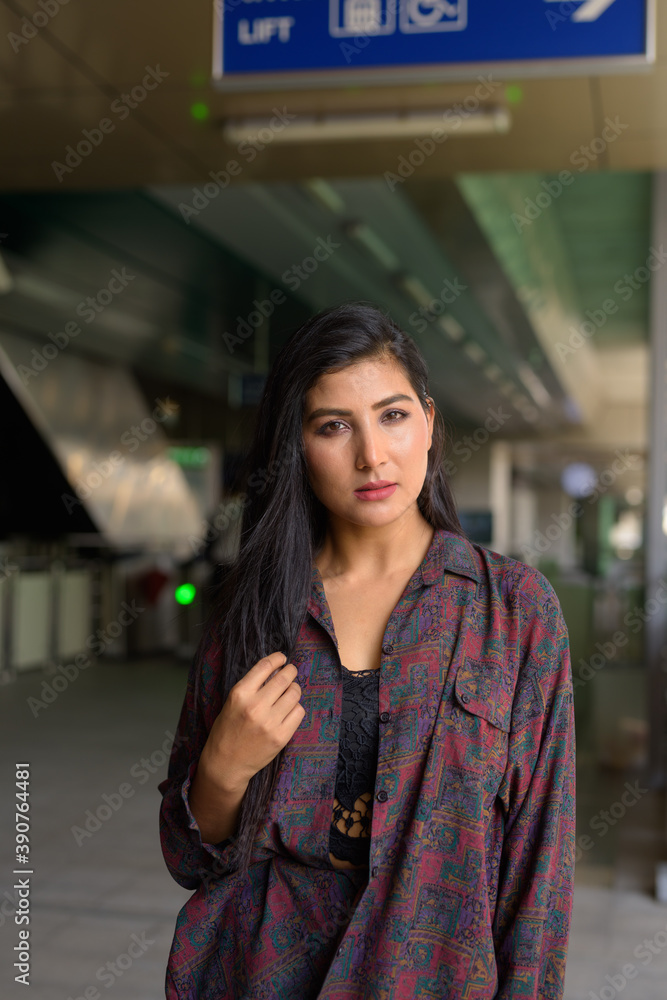 Fototapeta premium Portrait of beautiful young woman ready to travel vertical shot