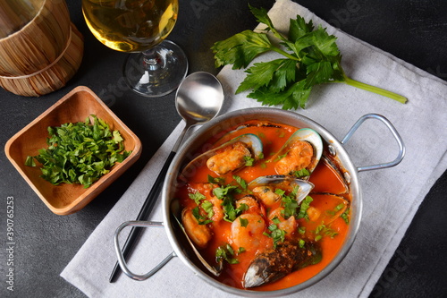 French seafood bouillabaisse soup/fish stew with mussels served with garlic toast baguette