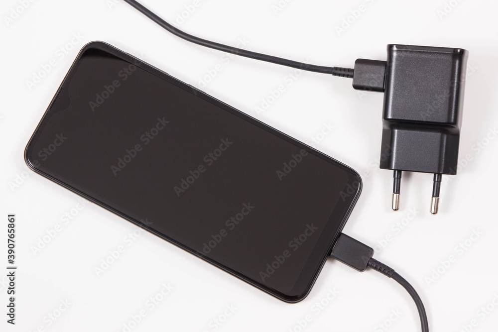 Mobile phone with connected plug of charger. Smartphone charging Mobile phone with connected plug of charger. Smartphone charging