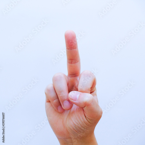 Close up Middle finger, offensive gesture, Top view man showing middle finger f you sign gesture on white background. horizontal, Male hand showing middle finger