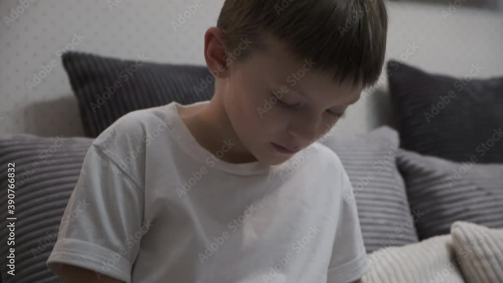 white boy enthusiastically reading a book on the couch white boy enthusiastically reading a book on the couch
