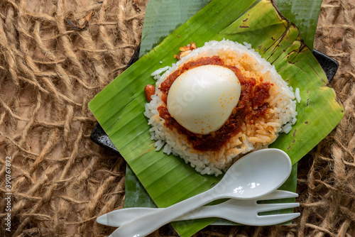 Simple Traditional popular Malaysian Nasi Lemak served on a banana leaf photo