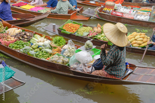 Damnoen Saduak Floating Market or Amphawa. Local people sell fruits, traditional food on boats in canal, Ratchaburi District, Thailand. Famous Asian tourist attraction destination. Festival in Asia. photo