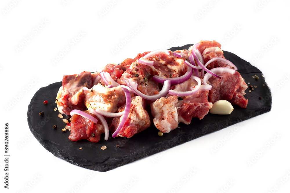 Pork, sliced, raw, with spices, horizontal, on a white plate, copy spaspce,