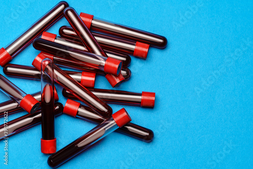 top view of medicine test tubes with blood samples over blue background