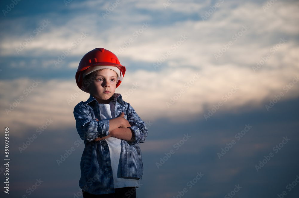 unemployment concept of upset little kid in red helmet and shirt standing on dusk blue cloud sky background with copy space unemployment concept of upset little kid in red helmet and shirt standing on dusk blue cloud sky background with copy space