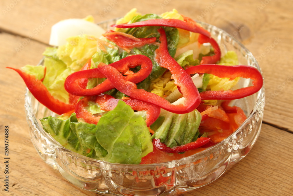 a glass bowl with fresh lettuce, bell pepper and egg a glass bowl with fresh lettuce, bell pepper and egg