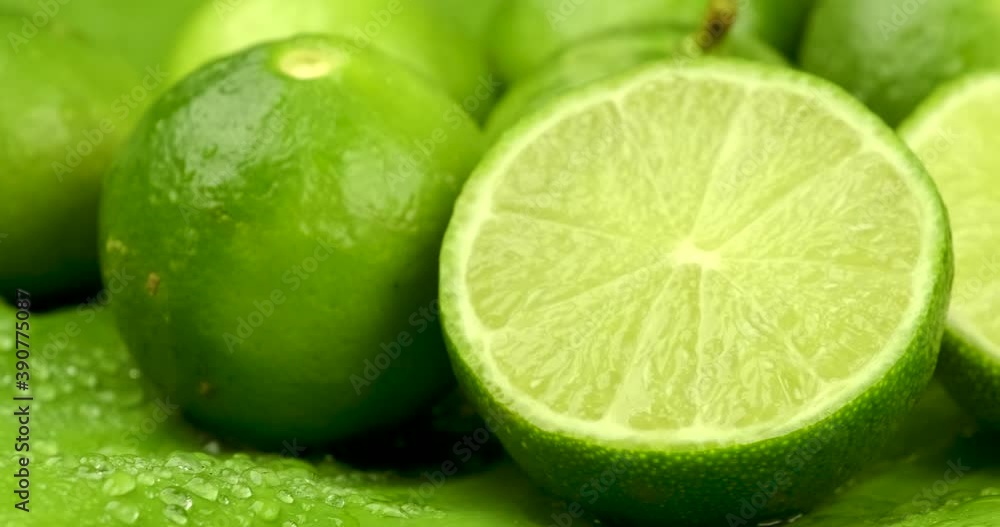 Truck shot close up of half and whole fresh lime juicy on green banana leaves with clearly water drop on surface Truck shot close up of half and whole fresh lime juicy on green banana leaves with clearly water drop on surface