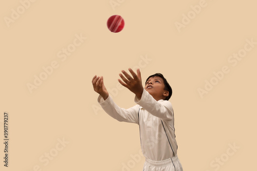 Boy catching cricket ball