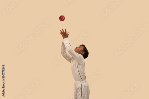 Boy catching cricket ball