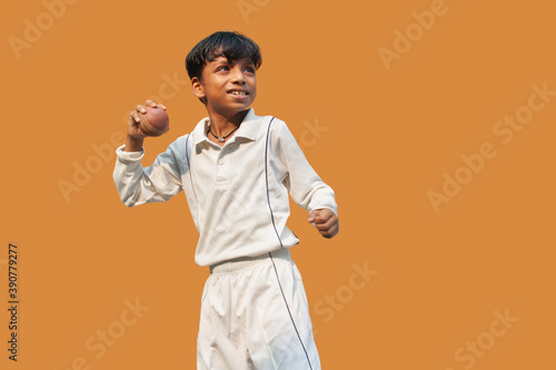 Photography A boy in cricket uniform standing Holding a ball