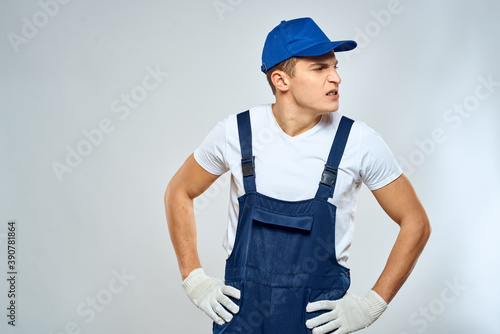 Man worker in forklift uniform delivery service light background