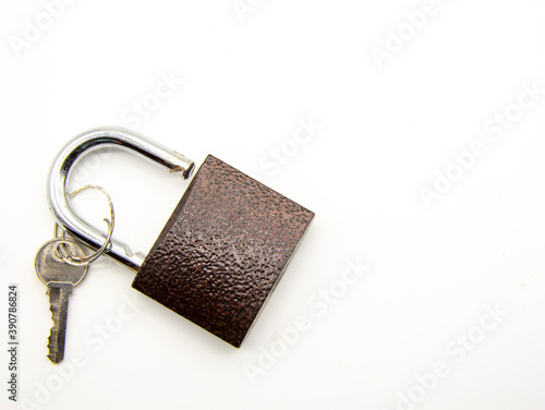 Metal padlock with key on white background.