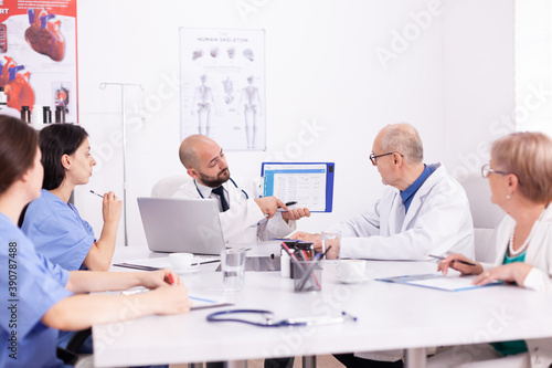 Healthcare specialist talking in conference room during medicine seminar. Clinic expert therapist discussing with colleagues about disease, medicine professional