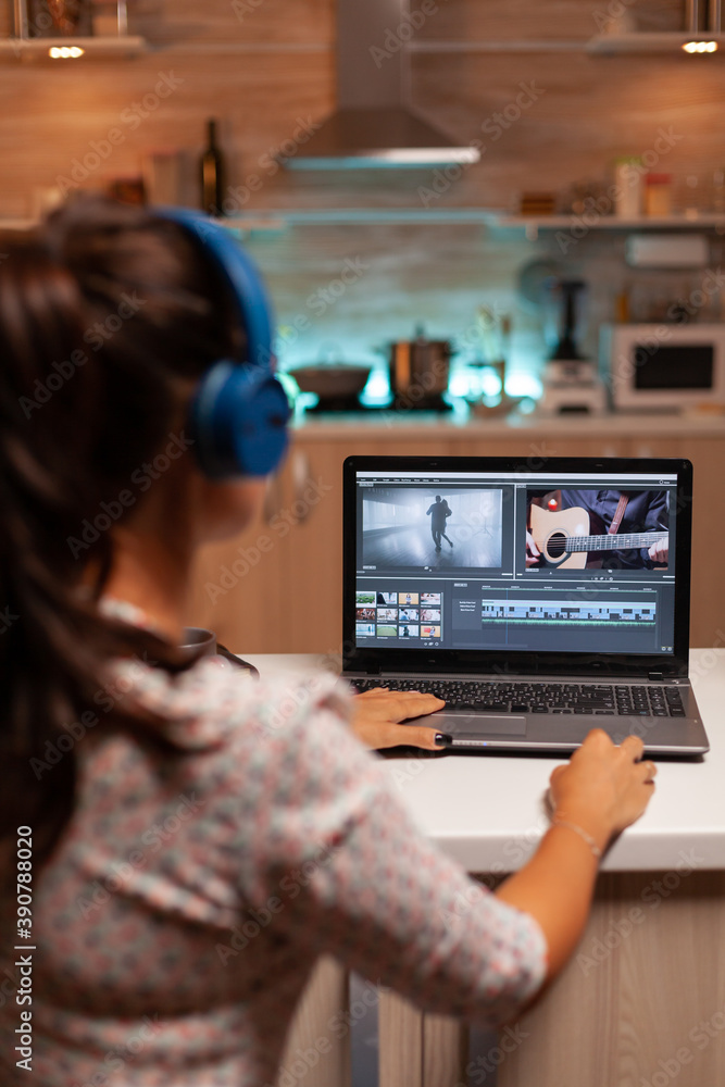 Movie maker editing a film using modern software for post production. Content creator in home working on montage of film using modern software for editing late at night. Movie maker editing a film using modern software for post production. Content creator in home working on montage of film using modern software for editing late at night.
