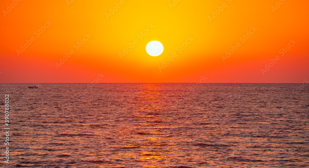 Amazing orange sunset with large yellow sun over the sea - Fethiye, Turkey