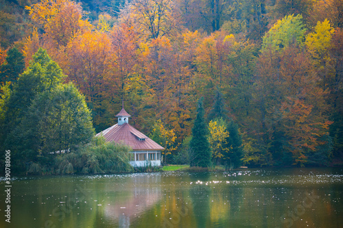 Abandanod cottage on autumn lake.