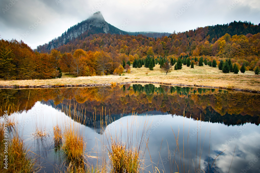 Beautiful, colorful autumn lake. Rooster’s Ridge, Gutaiului Mountains, Romania.