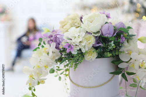 Artificial bouquet on a white shelf