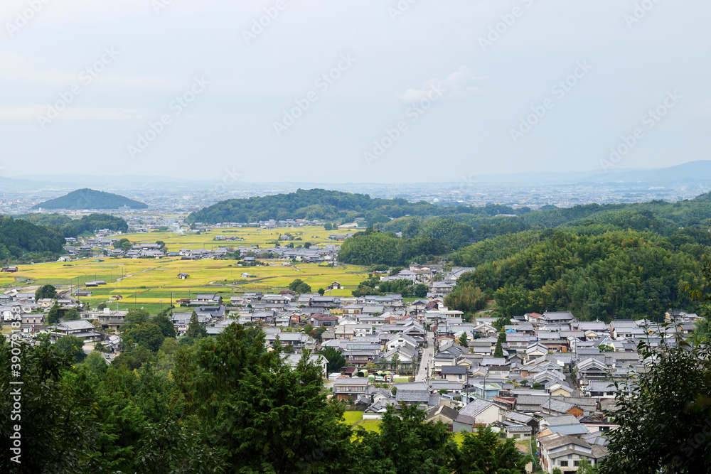 A bird's-eye view of an agricultural village in Nara, Japan, taken from the top of a mountain