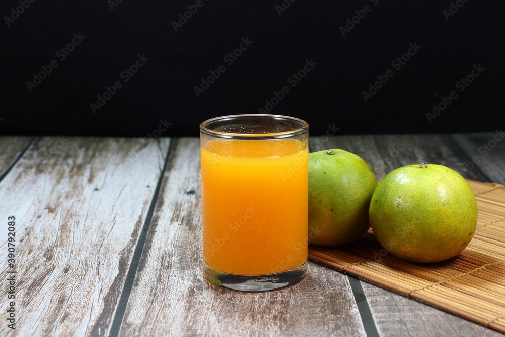Fresh orange juice in the clear glass. Famous traditional tropical beverage for woman in Asia. High vitamin and nutrition. Fresh orange juice in the clear glass. Famous traditional tropical beverage for woman in Asia. High vitamin and nutrition.