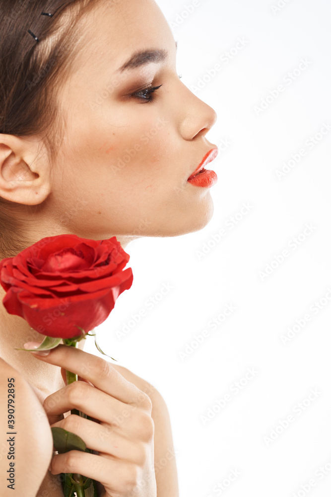 Beautiful woman with red rose near face makeup naked shoulders portrait Beautiful woman with red rose near face makeup naked shoulders portrait