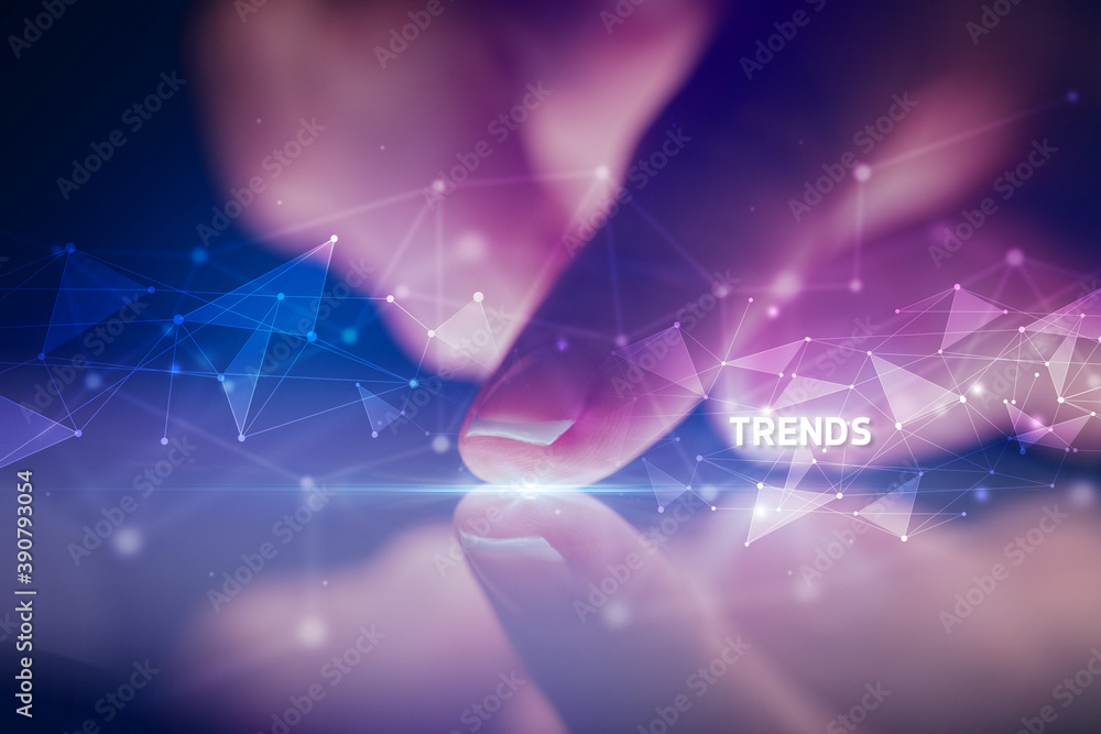 Fototapeta premium Finger touching tablet with TRENDS inscription, business concept