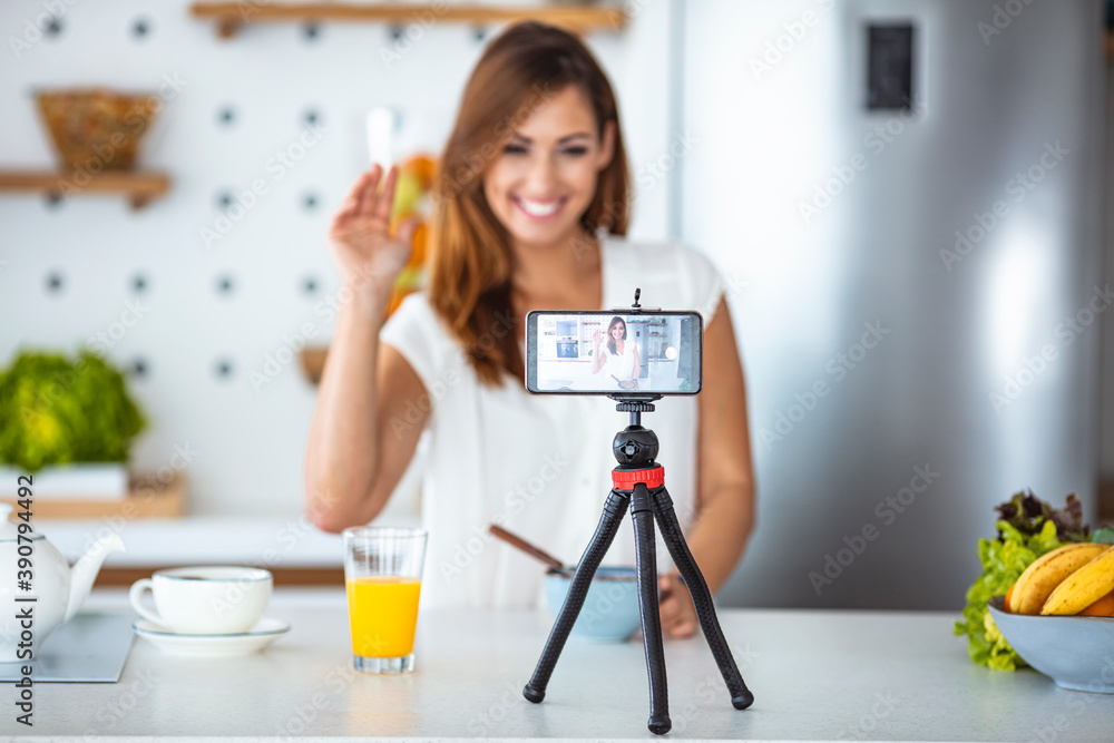 Young woman recording her vlog about healthy eating and nutritional supplements, close-up on a phone screen. Preventive medicine and influencer marketing concept Young woman recording her vlog about healthy eating and nutritional supplements, close-up on a phone screen. Preventive medicine and influencer marketing concept