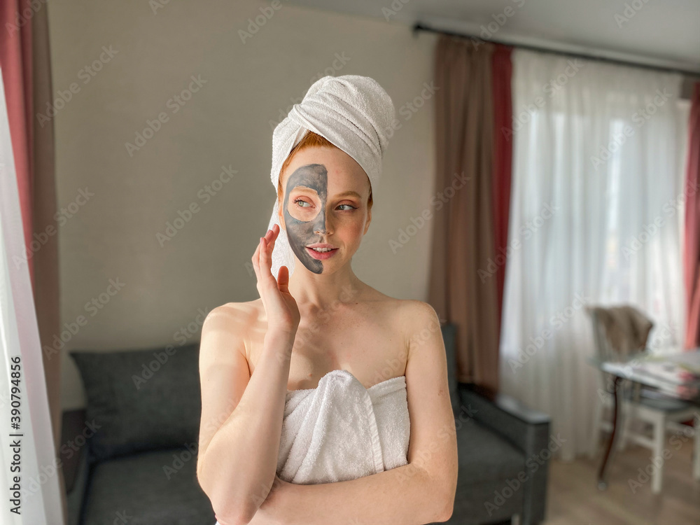 woman uses a gray clay face mask at home. secrets for skin care. woman uses a gray clay face mask at home. secrets for skin care.