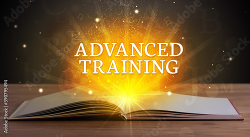 ADVANCED TRAINING inscription coming out from an open book, educational concept