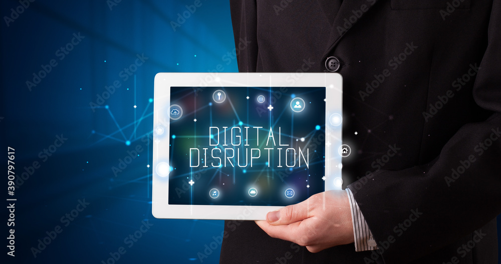 Young business person working on tablet and shows the digital sign: DIGITAL DISRUPTION Young business person working on tablet and shows the digital sign: DIGITAL DISRUPTION