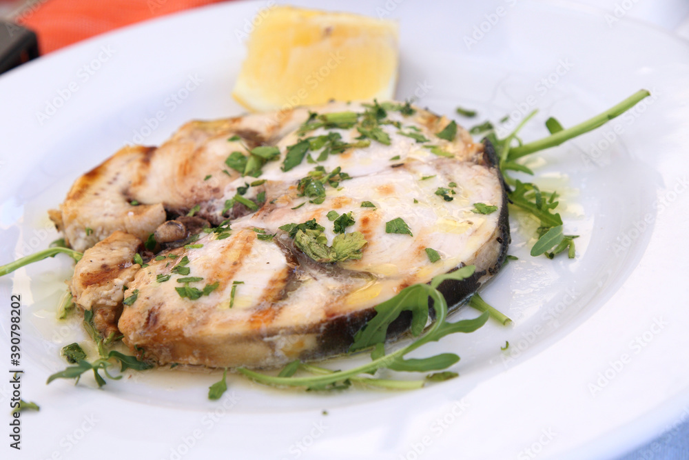cod fish served on a white plate cod fish served on a white plate