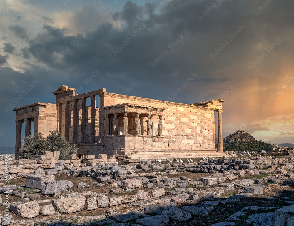 Athens Greece, scenic view of Caryatides statues on Erechtheion ancient temple facade under dramatic sky, filtered image
