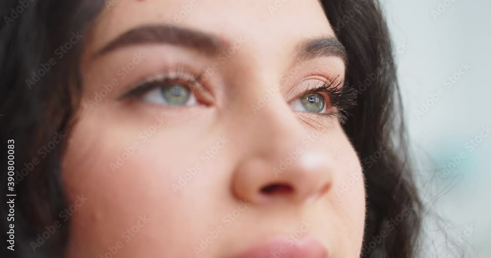 Close up of beautiful adult female face turning to camera indoors. Fascinating human wide grey eyes looking forward. Natural beauty. Close up of beautiful adult female face turning to camera indoors. Fascinating human wide grey eyes looking forward. Natural beauty.