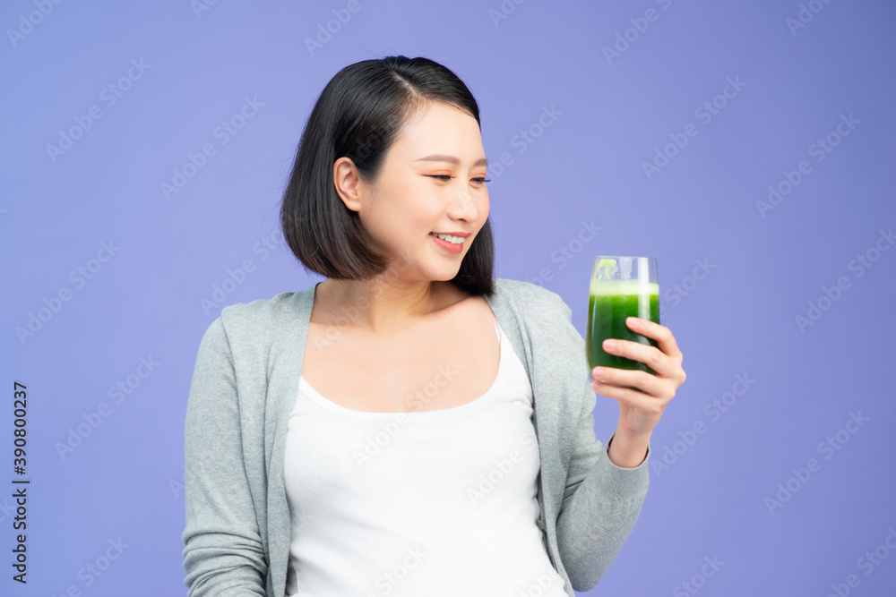 Pregnant woman with detox smoothie touching her belly Pregnant woman with detox smoothie touching her belly