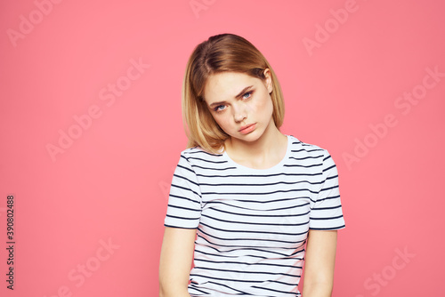 Woman in striped t-shirt emotions studio cropped view lifestyle pink isolated background