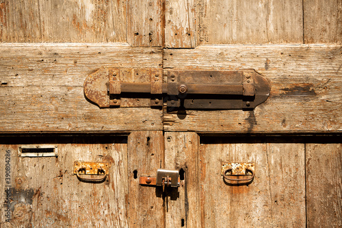 Close up detail of metal door latch on an old timber door
