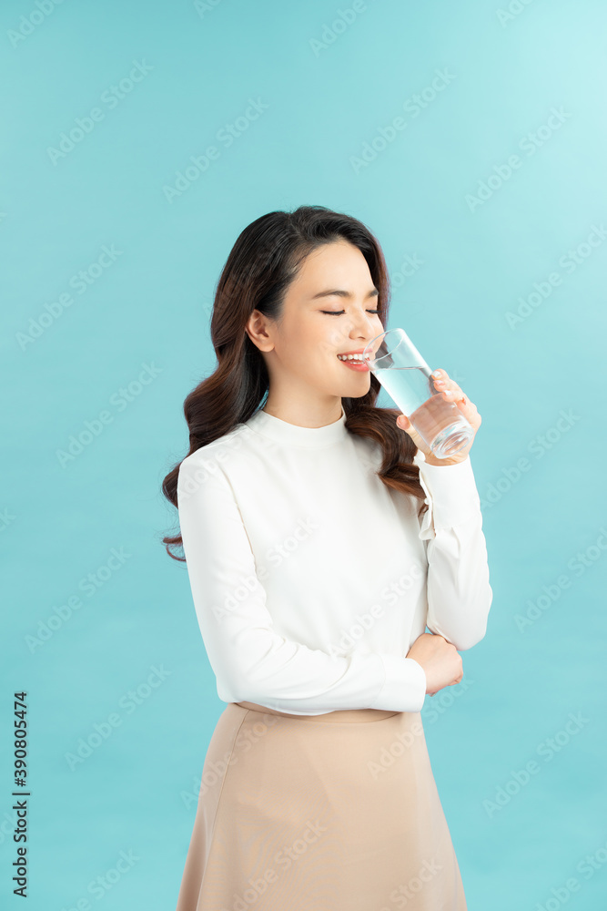 young woman drinks clean water adheres to drinking regime. young woman drinks clean water adheres to drinking regime.