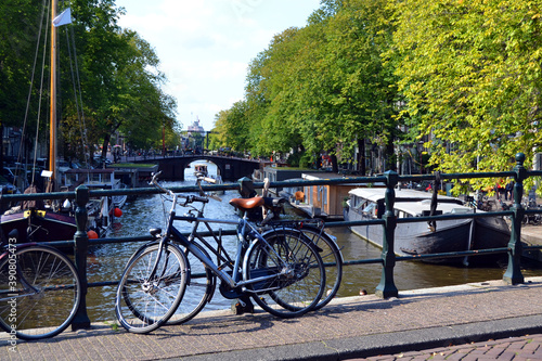 The canal, boats, bridge and bicycle parking. Amsterdam in summer time. The Netherlands.