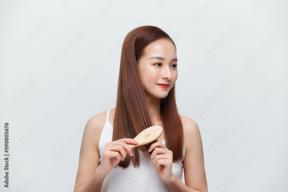 Woman with a comb in her hand on a white background Woman with a comb in her hand on a white background