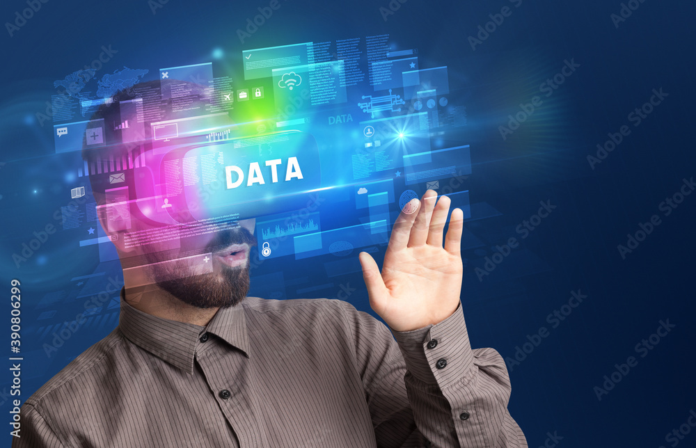 Businessman looking through Virtual Reality glasses with DATA inscription, innovative security concept Businessman looking through Virtual Reality glasses with DATA inscription, innovative security concept